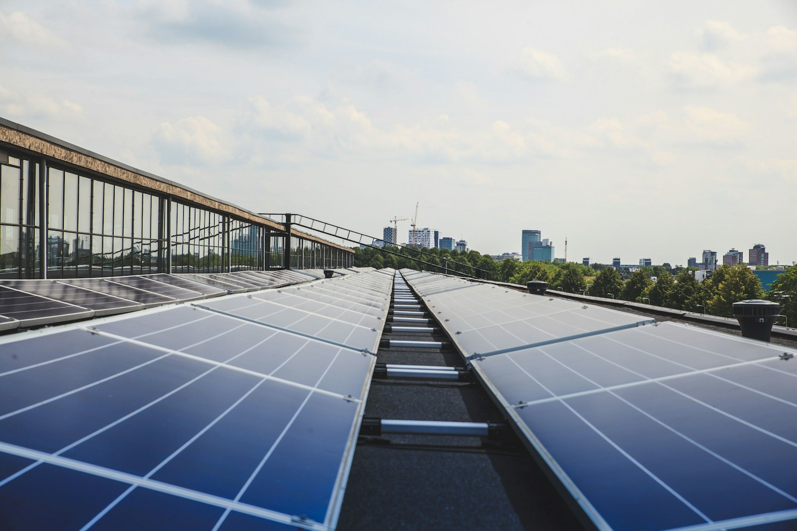 Telhado comercial com painéis solares e a cidade ao fundo